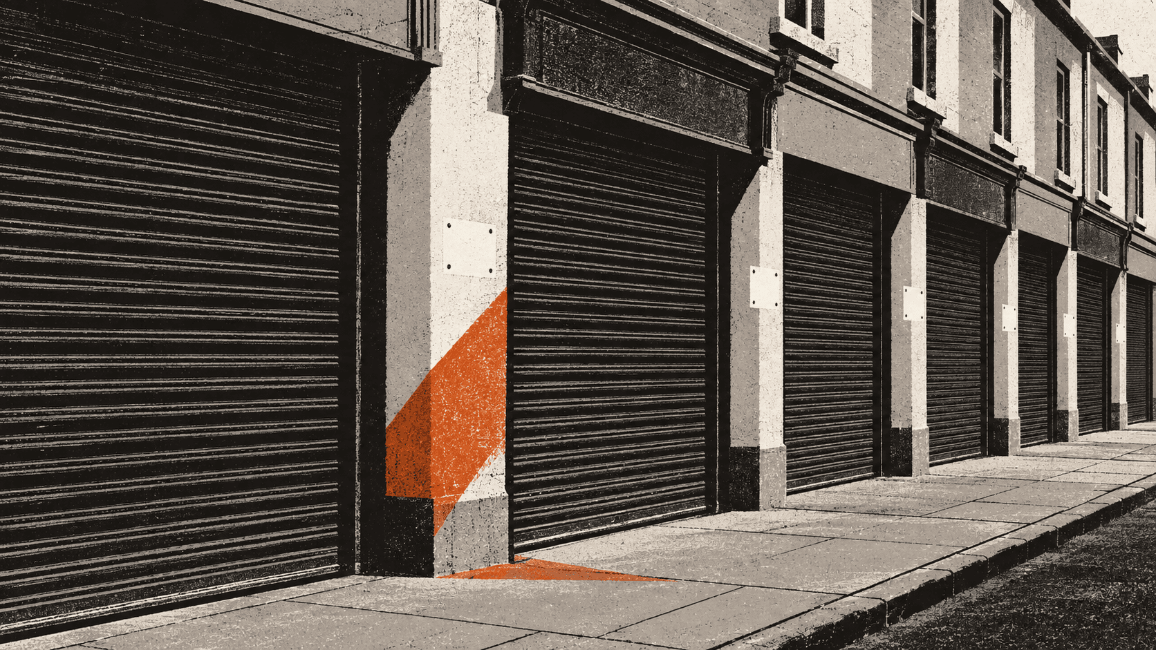 A row of shopfronts with their shutters lowered, each missing the small nameplate that once sat beside its door, leaving a pale unweathered patch on the wall.