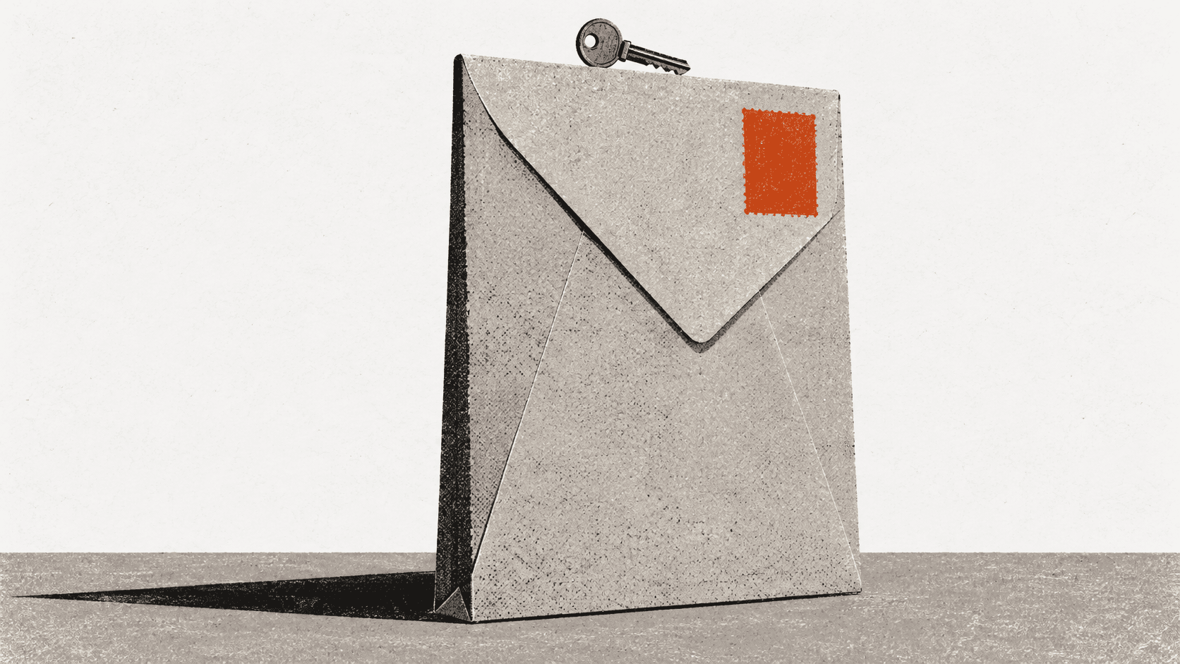 A giant sealed envelope stands upright alone on a bare floor with a small door key balanced on top of it.